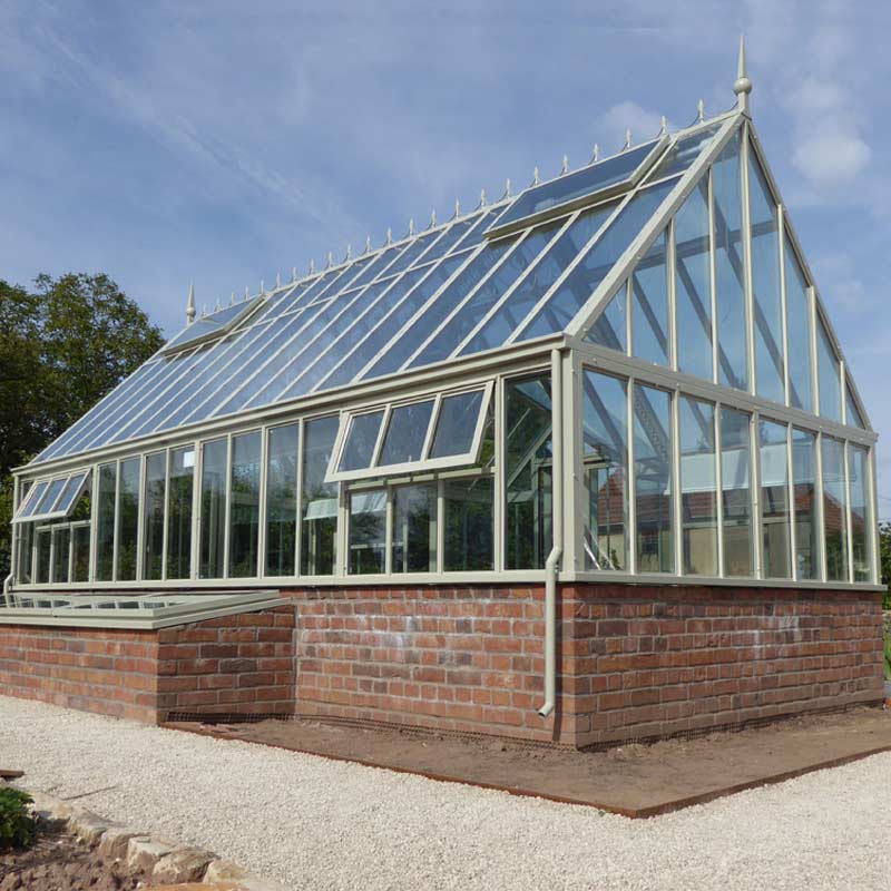 Modern grey conservatory attached to a stone house with wood ...